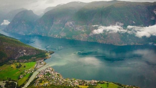 Clouds over fjord. Aurlandsfjord landscape at morning. Norway Scandinavia. National tourist route Aurlandsfjellet.