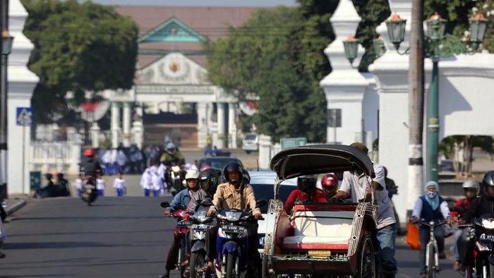 Yogyakarta, Indonesia - August 13, 2014: Varioius forms of transportation all together at a traffic stop in central Yogyakarta.