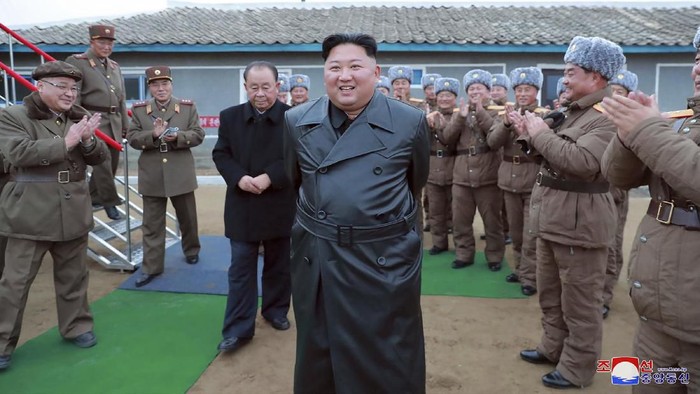 This undated photo provided on Friday, Nov. 29 2019, by the North Korean government, shows North Korean leader Kim Jong Un, center, surrounded by a military unit, reacts to what it claims as a test firing of its 