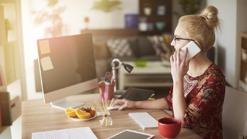 Picture of young man surprising woman with flowers