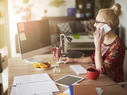 Picture of young man surprising woman with flowers