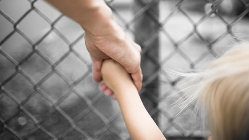 Mother and son holding hands.