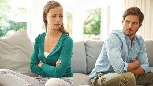 Focused man and woman sit on couch using laptop taking care of financial bills, husband and wife manage bank documents, reading regulations online, upset couple consider received papers