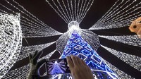 Seorang warga tengah memotret pohon Natal raksasa yang berada di Cathedral Square di kawasan Vilnius, Ibu Kota Lithuania.