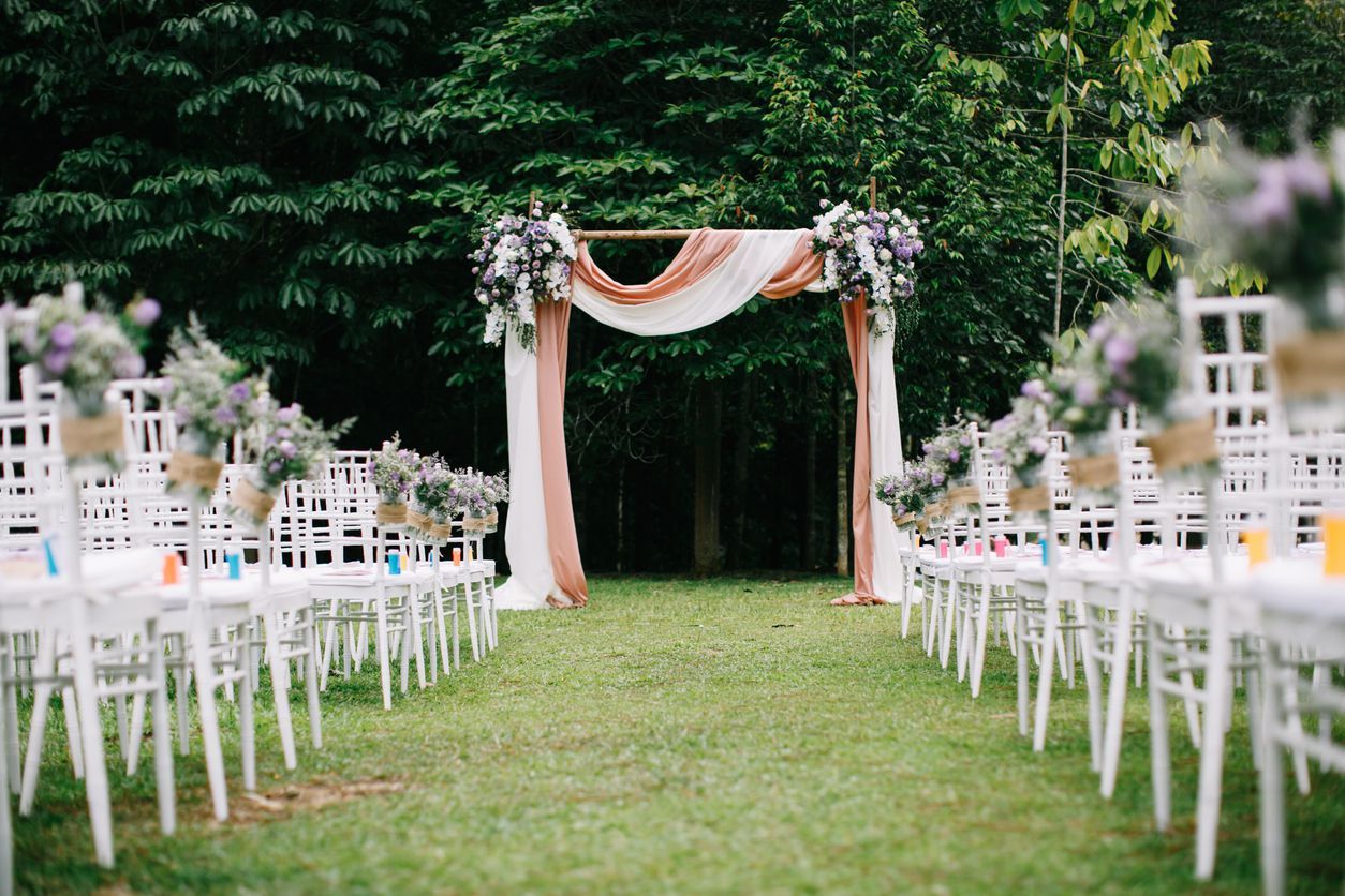 Outdoor wedding ceremony venue with arch and decoration