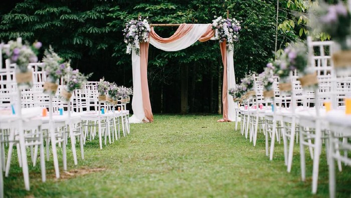 Outdoor wedding ceremony venue with arch and decoration
