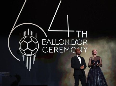 Former soccer player Didier Drogba, left, and Sandy Heribert presenters of the Golden Ball award ceremony speak at the Grand Palais in Paris, Monday, Dec. 2, 2019. Awarded every year by France Football magazine since Stanley Matthews won it in 1956, the Ballon d'Or, Golden Ball for the best player of the year will be given to both a woman and a man. (AP Photo/Francois Mori)