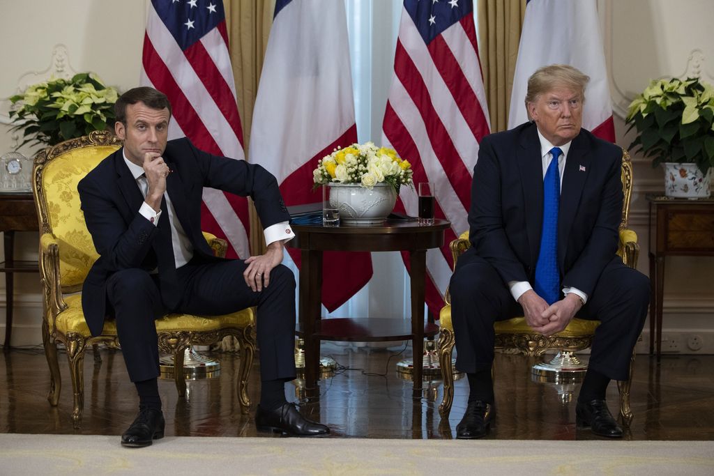 An interpreter translates for President Donald Trump as French President Emmanuel Macron speaks during a meeting at Winfield House during the NATO summit, Tuesday, Dec. 3, 2019, in London. (AP Photo/ Evan Vucci)