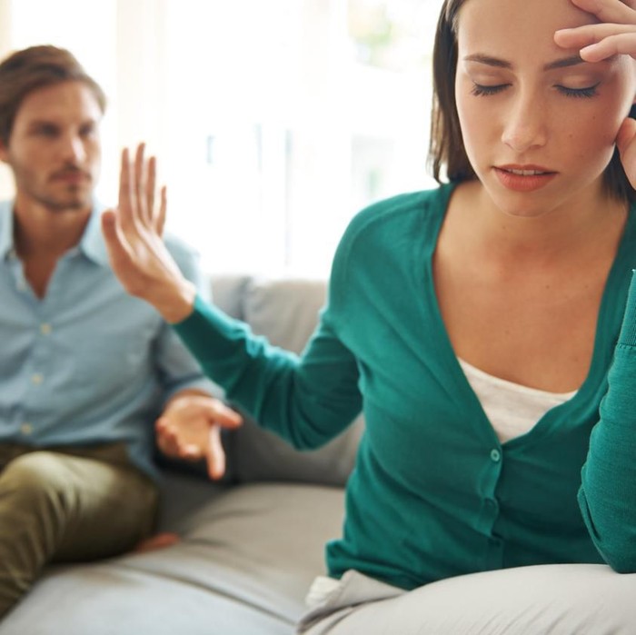 Shot of a young businesswoman looking stressed out in an office