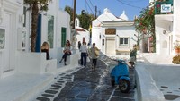 Gang-gang sempit berwarna putih dan biru begitu ikonik dengan Mykonos, Yunani. Setiap musim panas, tempat ini selalu menjadi tujuan para turis. (iStock)