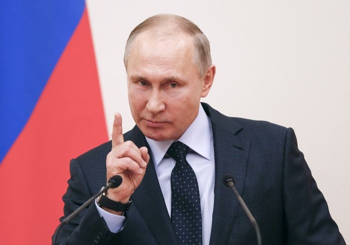 (FILES) In this file photo taken on January 31, 2018 Russian President Vladimir Putin delivers a speech during a meeting with Russian athletes and team members, who will take part in the upcoming 2018 Pyeongchang Winter Olympic Games, at the Novo-Ogaryovo state residence outside Moscow. - Russia will miss next years Tokyo Olympics and the 2022 Beijing Winter Games after the World Anti-Doping Agency on Monday banned the powerhouse from global sporting events for four years over manipulated doping data. (Photo by GRIGORY DUKOR / POOL / AFP)