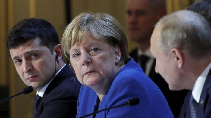 Ukraines President Volodymyr Zelenskiy smiles during a joint press conference with German Chancellor Angela Merkel, French President Emmanuel Macron and Russian President Vladimir Putin at the Elysee Palace in Paris, Monday Dec. 9, 2019. Russian President Vladimir Putin and Ukrainian President Volodymyr Zelenskiy met for the first time Monday at a summit in Paris to try to end five years of war between Ukrainian troops and Russian-backed separatists. (Ludovic Marin/Pool via AP)
