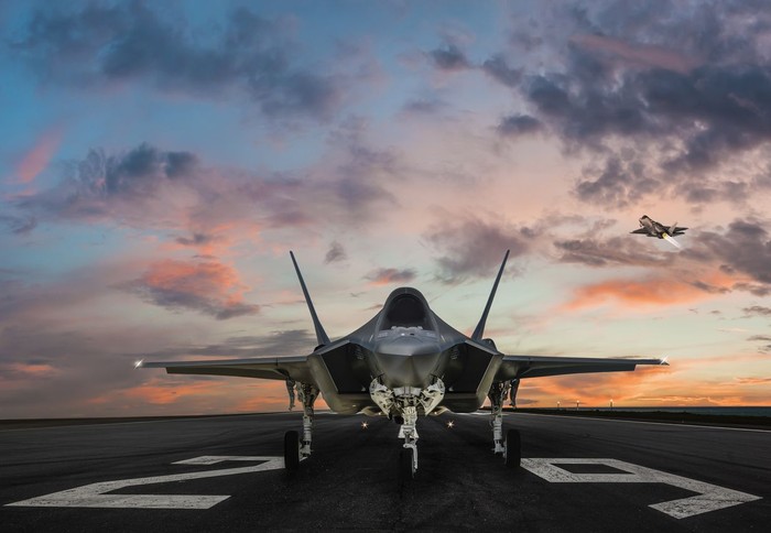 F-35 fighter jet ready to takeoff on runway at sunset
