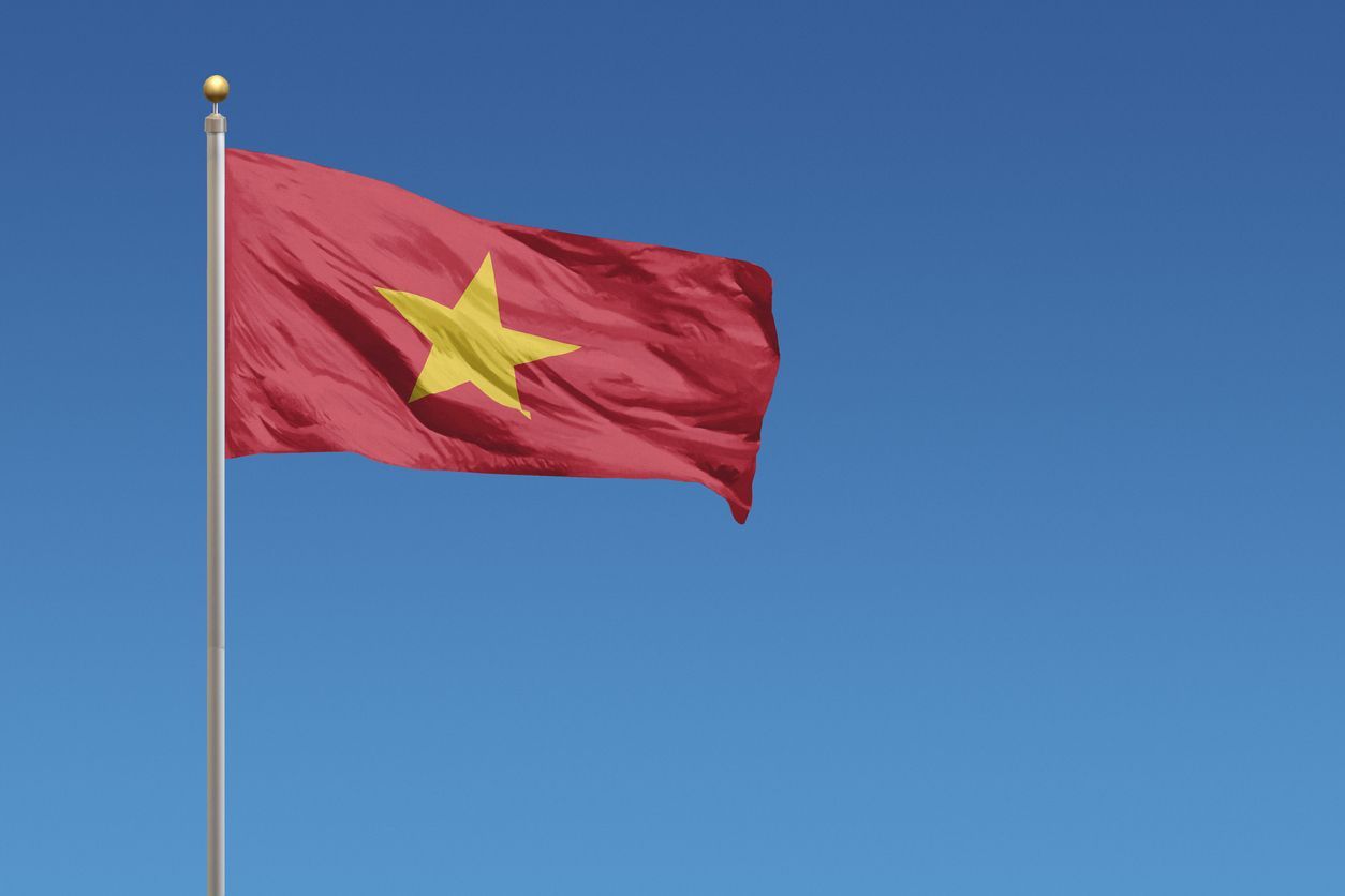 Flag of Vietnam in front of a clear blue sky