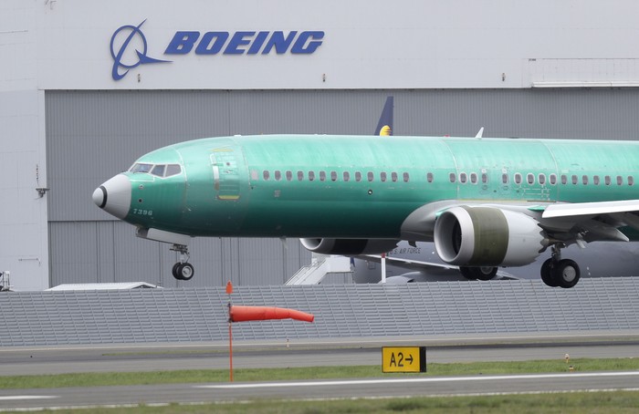 FILE - In this April 10, 2019, file photo a Boeing 737 MAX 8 airplane being built for India-based Jet Airways lands following a test flight at Boeing Field in Seattle. Boeing is reassuring airline industry leaders about the safety of the grounded 737 Max as it continues working to get the plane back in service. The aircraft maker invited about 30 union officials, safety experts and others to the Seattle area for two days of meetings with Boeing executives and factory tours. (AP Photo/Ted S. Warren, File)