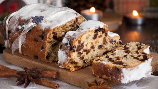 Sliced Christmas Stollen. Traditional german christmas cake with dried fruits and icing sugar.