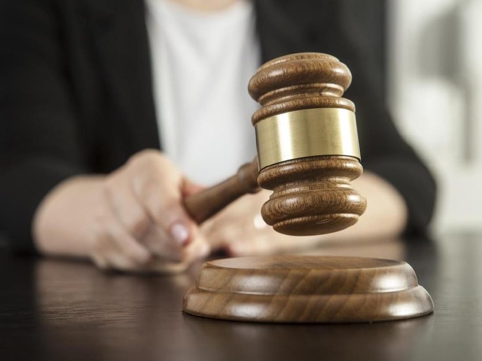 Caucasian woman holding gavel