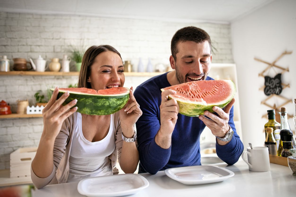Young couple eating watermelon