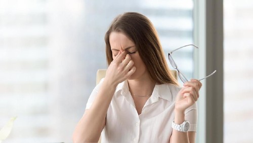 Beautiful young woman working using computer skeptic and nervous, disapproving expression on face with crossed arms. Negative person.