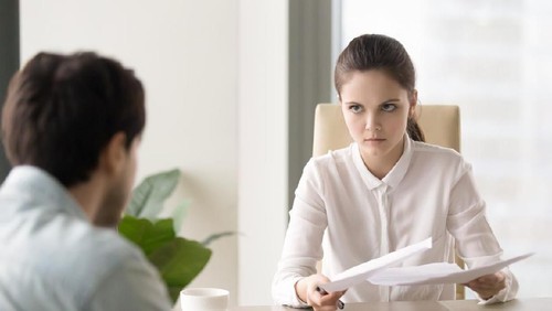 Beautiful young woman working using computer skeptic and nervous, disapproving expression on face with crossed arms. Negative person.