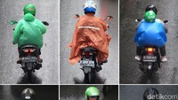 Sejumlah pengendara motor mengenakan jas hujan beragam warna saat beraktivitas di luar ruangan saat hujan mengguyur kawasan Jakarta, Selasa (17/12/2019).