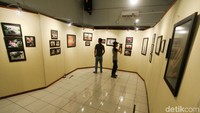 Dua orang pengunjung melihat-lihat foto yang dipamerkan.