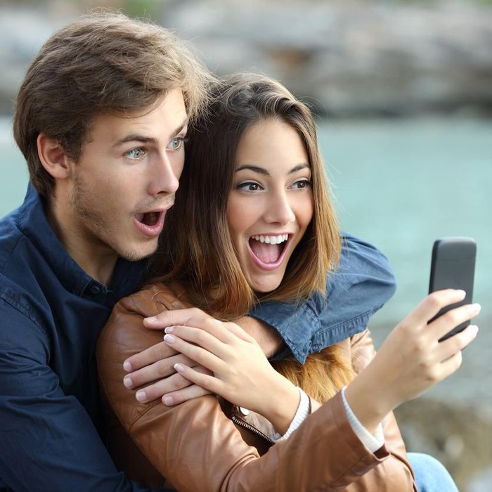 Profile side view portrait of two nice lovely attractive sweet cheerful cheery people husband wife sitting on divan discussing news in white light interior room