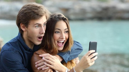Profile side view portrait of two nice lovely attractive sweet cheerful cheery people husband wife sitting on divan discussing news in white light interior room