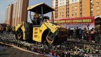 Botol-botol miras tersebut dimusnahkan dengan menggunakan buldozer.