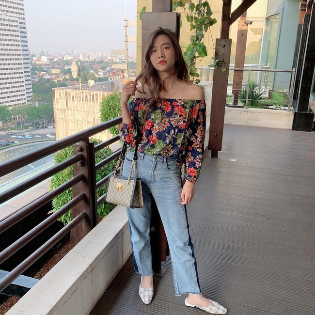 Shania dalam balutan atasan off-shoulder bermotif floral dan jeans. Ia juga menyempurnakan gayanya dengan tas Gucci. (Foto: Instagram/@shanju)