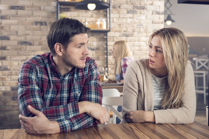 zodiak Unhappy young couple arguing standing at house door, angry husband pointing at wife blaming her of problems, conflicts in marriage, bad relationships, man and woman having quarrel or disagreement