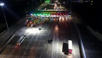 Begini penampakan gerbang Tol Cikampek Utama yang terpantau lancar malam ini, Senin (23/12/2019).