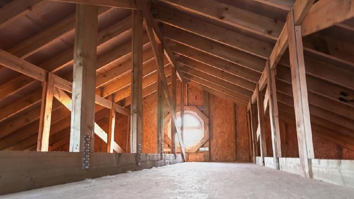 Attic with wooden beams inside a new house under construction