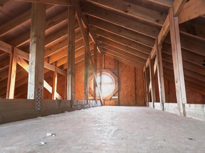 Attic with wooden beams inside a new house under construction