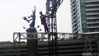 Pekerja merangkai besi-besi penyangga panggung.