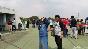 Jakarta sempat berawan menjelang Gerhana Matahari Cincin. Tapi akhirnya orang-orang bisa melihat jelas dan puas hatinya (detikINET/Aisyah Kamaliah)