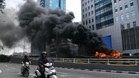 Prajurit TNI bersama sejumlah warga memadamkan api yang membakar bus Brimob di kawasan Slipi, Jakarta. Diketahui ada 2 bus Brimob yang terbakar di sana. Antara Foto/Sigid Kurniawan.
