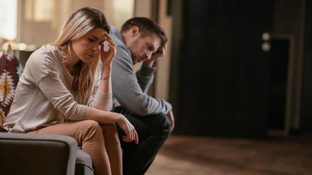 1087169152 Unhappy young couple. Shallow DOF. Developed from RAW; retouched with special care and attention; Small amount of grain added for best final impression. 16 bit Adobe RGB color profile.