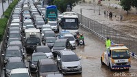 Pengendara sepeda motor melintas di antara mobil pribadi dan bus di Tol Kebon Jeruk, Jakarta Barat, Rabu (1/1/2020).