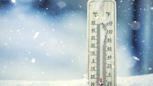 Thermometer on snow shows low temperatures under zero. Low temperatures in degrees Celsius and fahrenheit. Cold winter weather twenty under zero.Thermometer on snow shows low temperatures under zero. Low temperatures in degrees Celsius and fahrenheit. Cold winter weather twenty under zero.