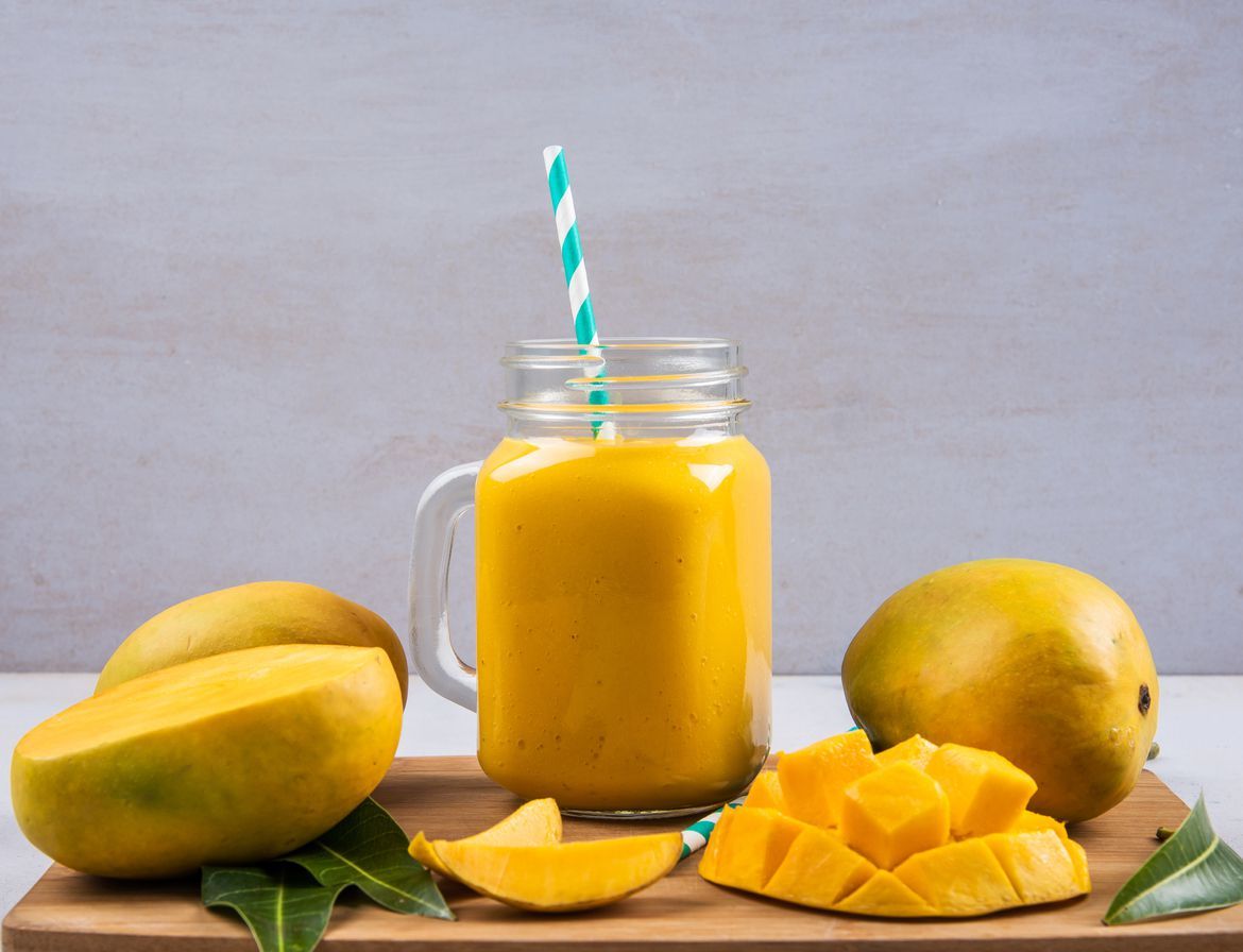 Mango Smoothie In A Bottle With Slices Of Mango Fruit
