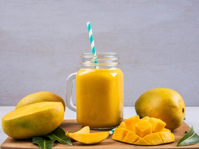Mango Smoothie In A Bottle With Slices Of Mango Fruit