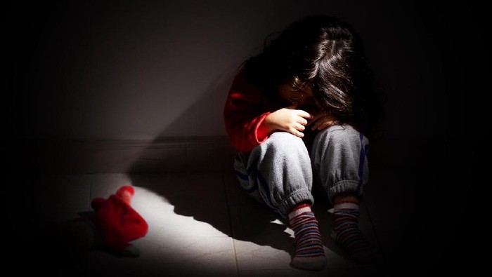 507458304 little child girl crying and sad about an empty brick wall