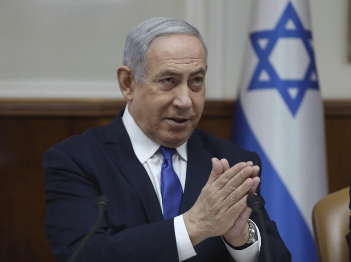 File - In this Sunday, Dec. 29, 2019 file photo, Israeli Prime Minister Benjamin Netanyahu attends the weekly cabinet meeting at his office in Jerusalem. Netanyahu said Monday that he would seek immunity from corruption charges, likely delaying any trial until after March elections, when he hopes to have a majority coalition that will shield him from prosecution. (Abir Sultan /Pool photo via AP, File)