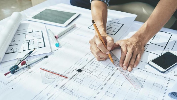Close-up image of engineerr drawing blueprint