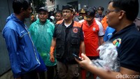 Anies nampak berkoordinasi dengan jajarannya saat ikut serta dalam kerja bakti membersihkan sampah sisa banjir di Jakarta Timur.