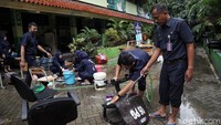 Sejumlah bangku tengah dibersihkan oleh para guru.