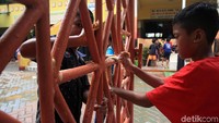Sejumlah anak juga turut membersihkan pagar sekolah yang kotor akibat terendam banjir.