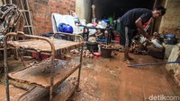 Warga membersihkan perabotan rumahnya.