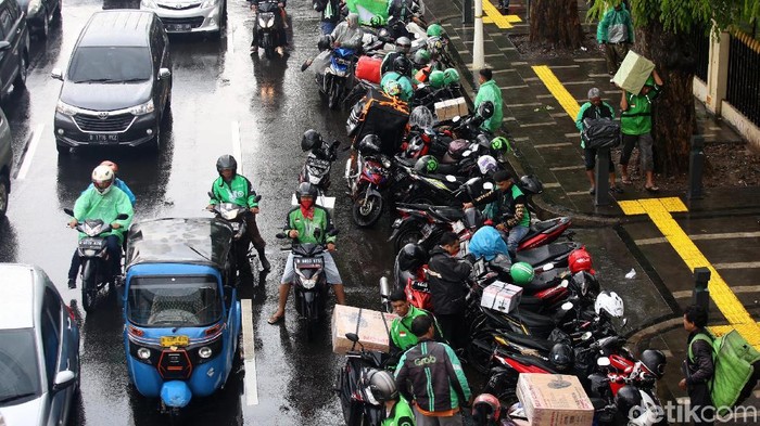 Arus lalu lintas di kawasan Jl Salemba sedikit tersendat akibat sejumlah ojol yang memarkir kendaraannya di sisi trotoar yang sedang viral karena PKL.